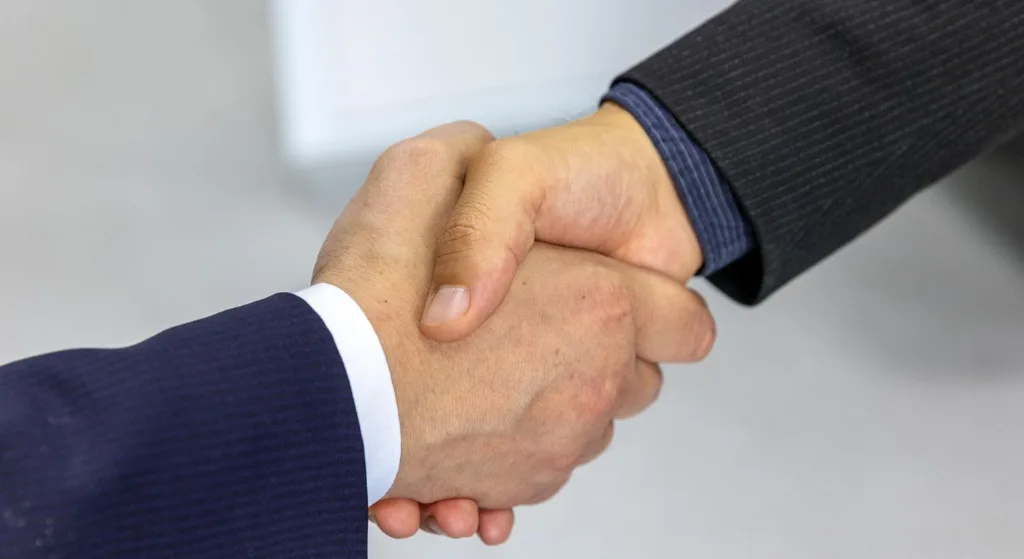 Close-up of two businessmen shaking hands, symbolizing agreement and partnership